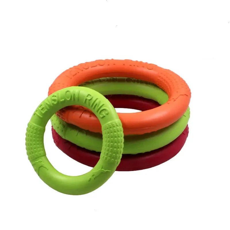 Pet flying discs in vibrant orange, red, and green for dog training and interactive play.